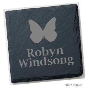 Square mockup image showing a dark gray stone tile with a butterfly outline and the name Robyn Windsong lasered into the stone tile commemorative plaque. 