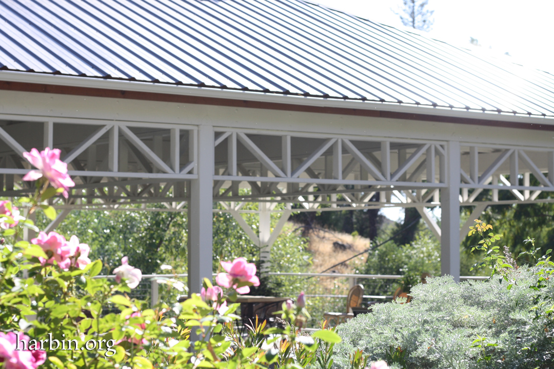 New Garden Pavilion is an outdoor pavilion structure with pink roses in the foreground.