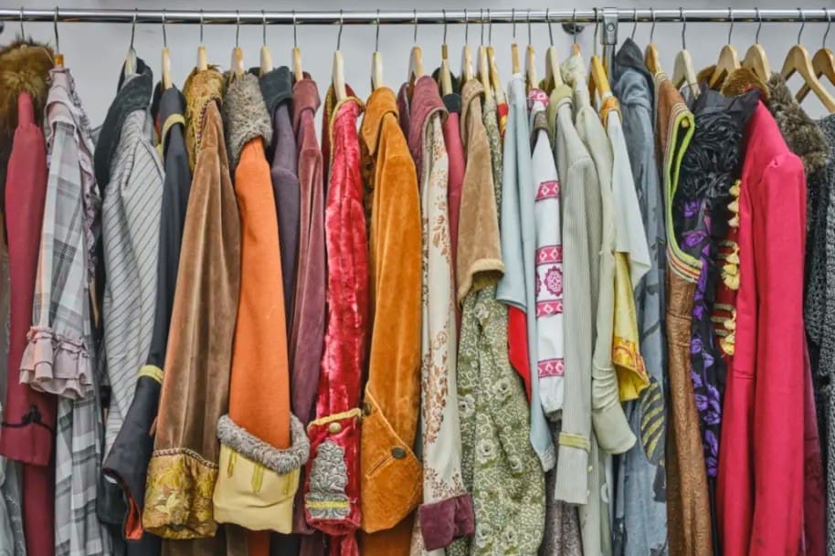 Colorful coats in a wardrobe.