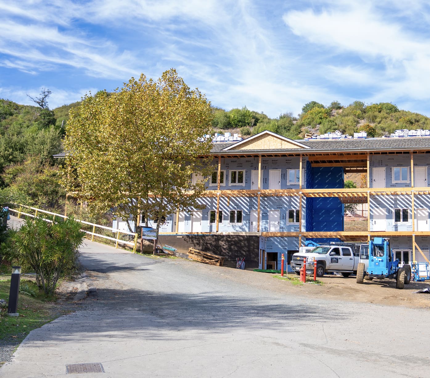 Hotel under construction with blue sky above.